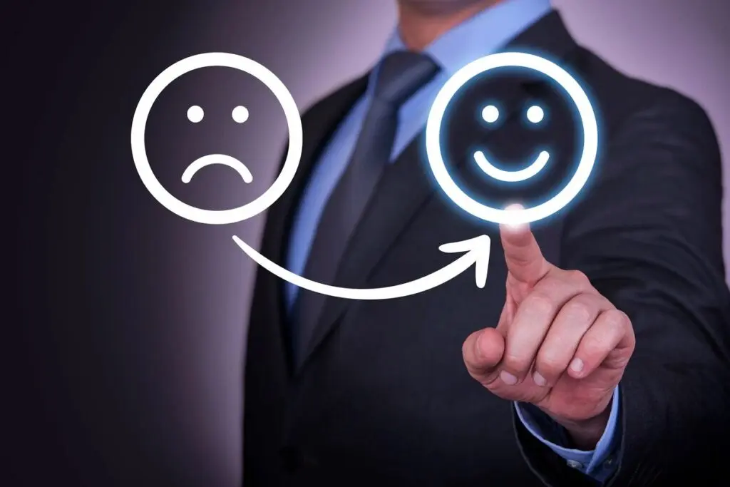 Person pointing at a happy face, illustrating the benefits of CBT cognitive behavioral therapy.