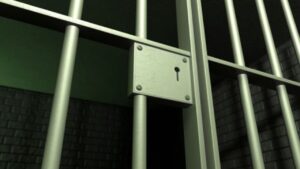 Prison cell bars symbolizing the debate of incarceration vs. rehabilitation for drug and alcohol treatment.