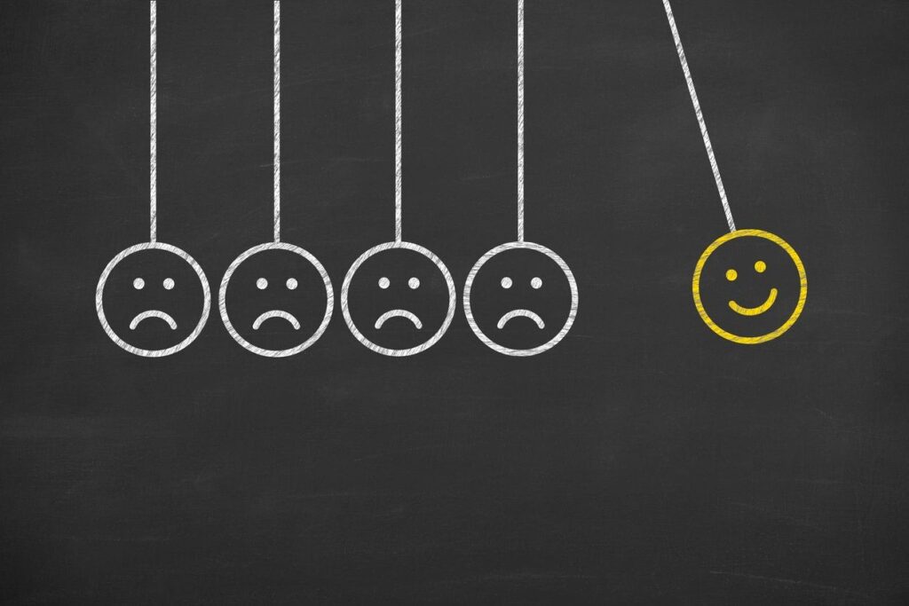 Illustration of frowning faces transforming into a smiling face, symbolizing CBT cognitive behavioural therapy.